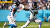 Seattle Seahawks wide receiver Jaxon Smith-Njigba (11) throws the stiff arm to Tennessee Titans safety Kevin Winston Jr. (23) during the second quarter at Nissan Stadium in Nashville, Tenn., Sunday, Nov. 23, 2025.