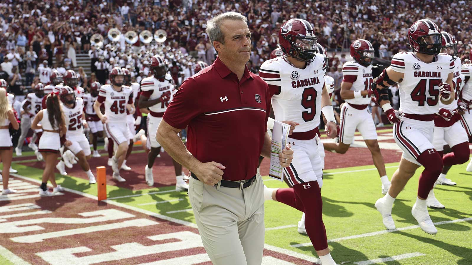 South Carolina Gamecocks head coach Shane Beamer runs onto the field with players before the game against the Texas A&M Aggies at Kyle Field.