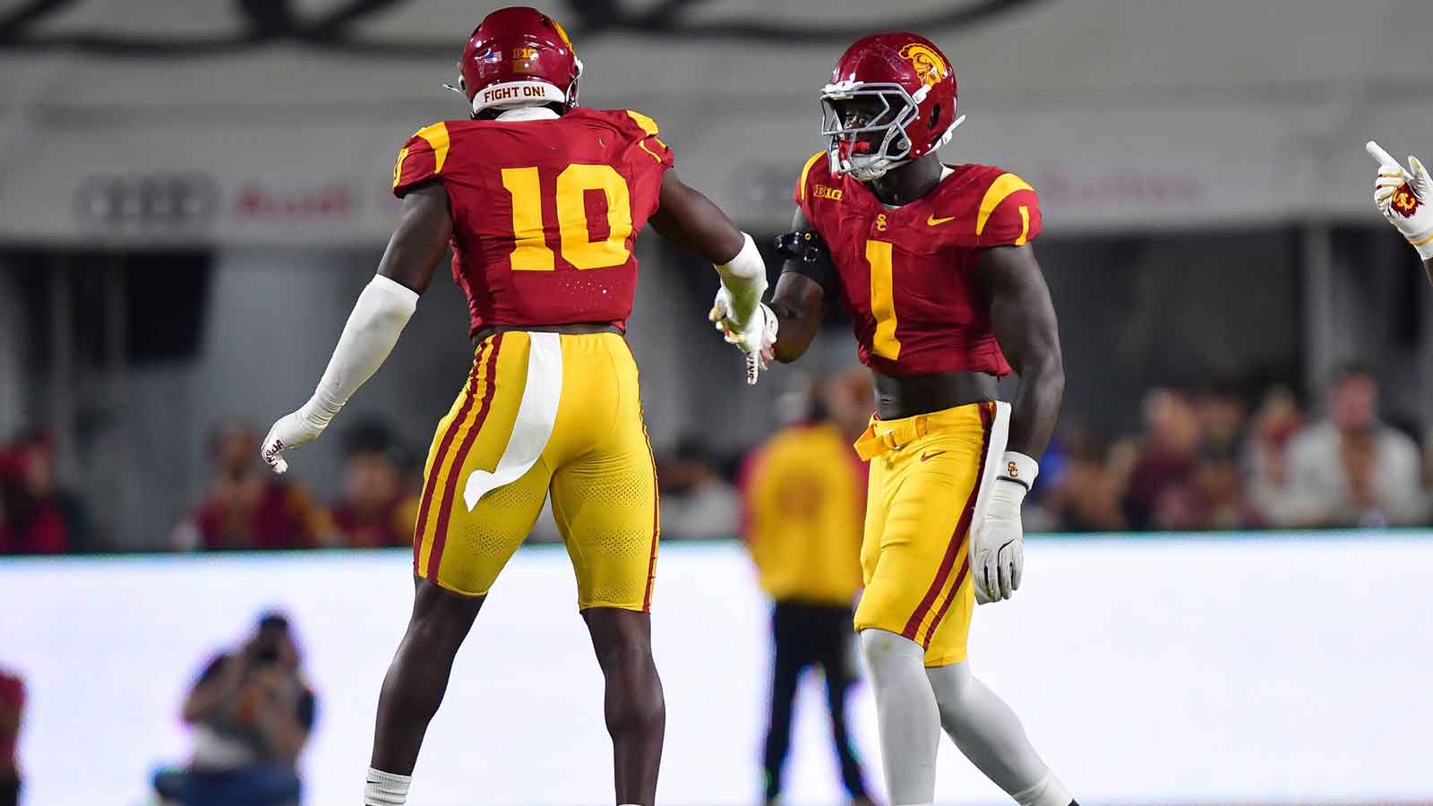 Southern California Trojans defensive end Braylan Shelby (10) celebrates with defensive end Kameryn Crawford (1) after bringing down Michigan State Spartans quarterback Aidan Chiles (2) during the first half at the Los Angeles Memorial Coliseum. 