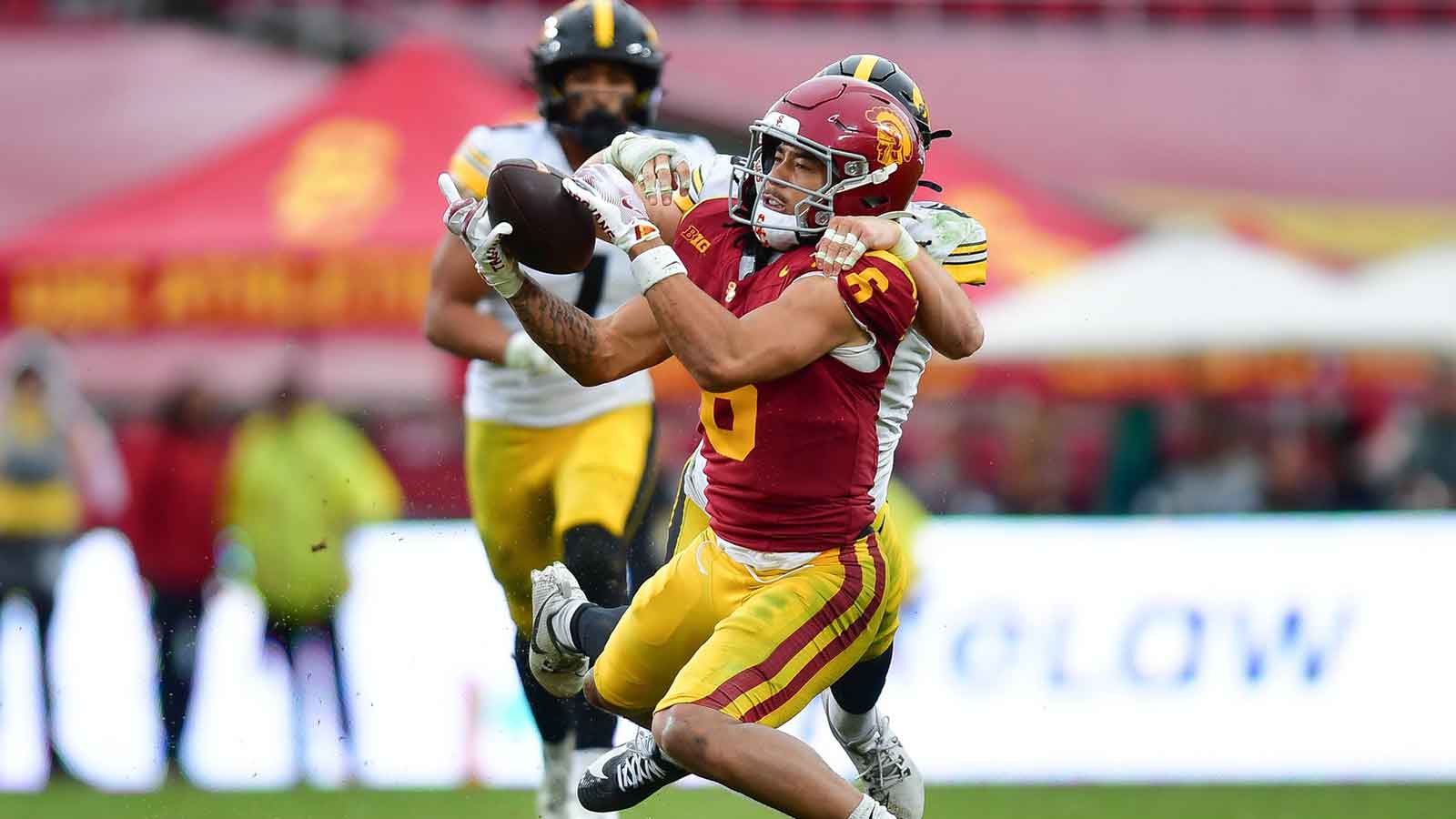 Southern California Trojans wide receiver Makai Lemon (6) catches a pass against the defense of Iowa Hawkeyes defensive back Zach Lutmer (6) during the second half at the Los Angeles Memorial Coliseum. 