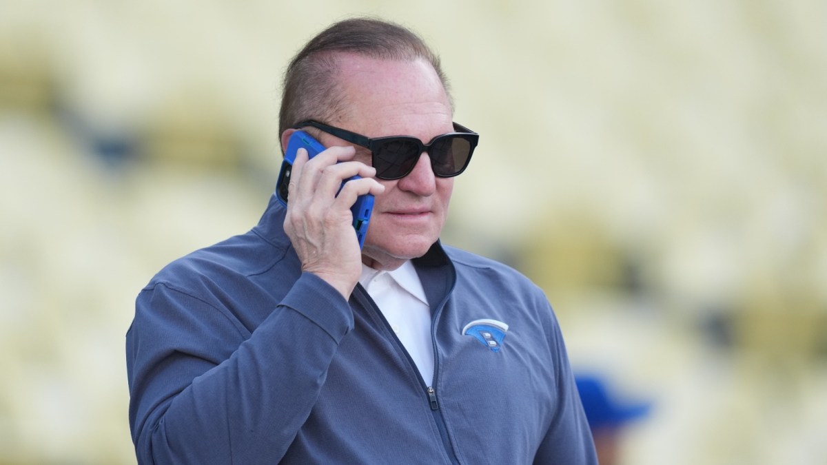 Sports agent Scott Boras talks on a cell phone before a game between the Colrorado Rockies and Los Angeles Dodgers at Dodger Stadium.