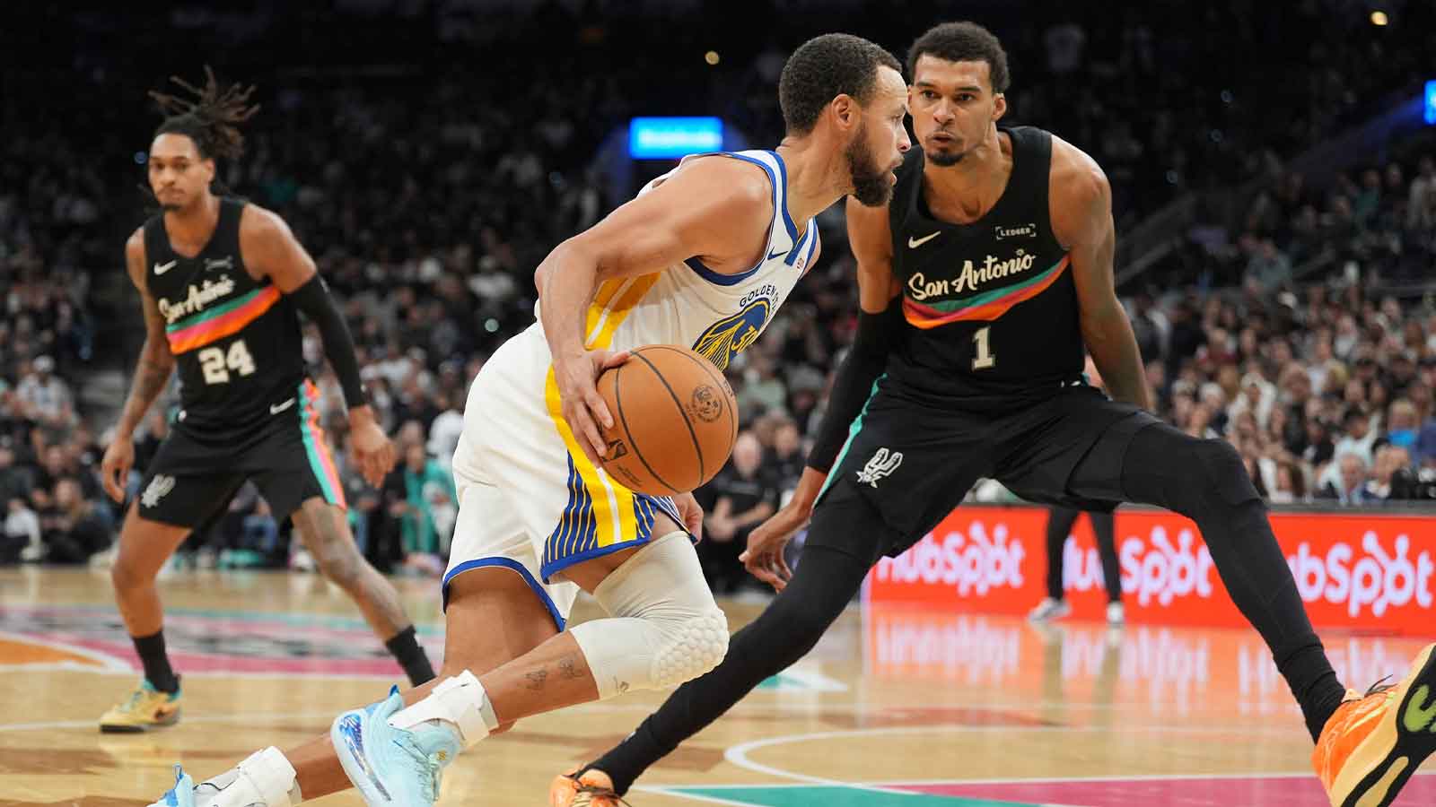 Warriors guard Stephen Curry (30) dribbles against San Antonio Spurs forward Victor Wembanyama (1) in the second half at Frost Bank Center