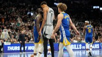 Golden State Warriors forward Draymond Green (23) and San Antonio Spurs forward Victor Wembanyama (1) exchange words during the second half at Frost Bank Center.