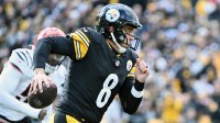 Pittsburgh Steelers quarterback Aaron Rodgers (8) runs with the ball against the Cincinnati Bengals during the first half at Acrisure Stadium.