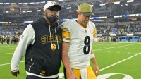 Pittsburgh Steelers head coach Mike Tomlin and quarterback Aaron Rodgers (8) walk off the field after the game against the Los Angeles Chargers at SoFi Stadium.