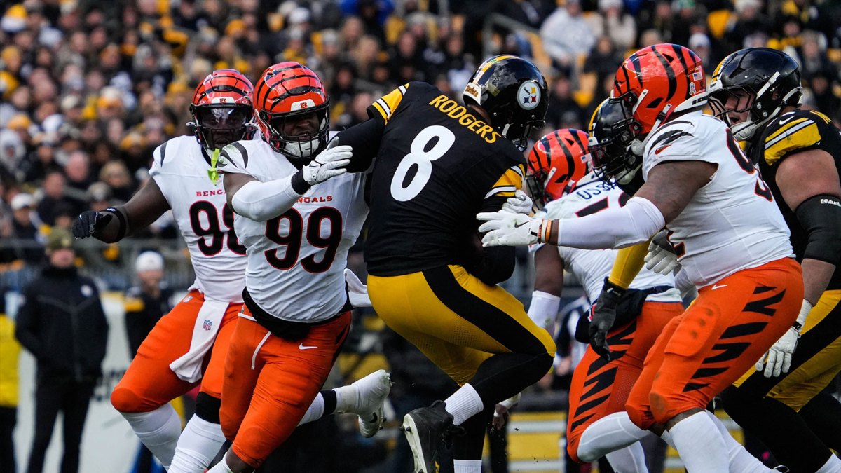 Bengals defense rushes to take down Steelers Aaron Rodgers (8) during their game against the Steelers on Sunday November 16, 2025 at Acrisure Stadium.