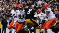 Bengals defense rushes to take down Steelers Aaron Rodgers (8) during their game against the Steelers on Sunday November 16, 2025 at Acrisure Stadium.