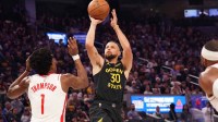 Nov 26, 2025; San Francisco, California, USA; Golden State Warriors guard Stephen Curry (30) shoots while defended by Houston Rockets guard-forward Amen Thompson (1) in the second quarter at Chase Center.