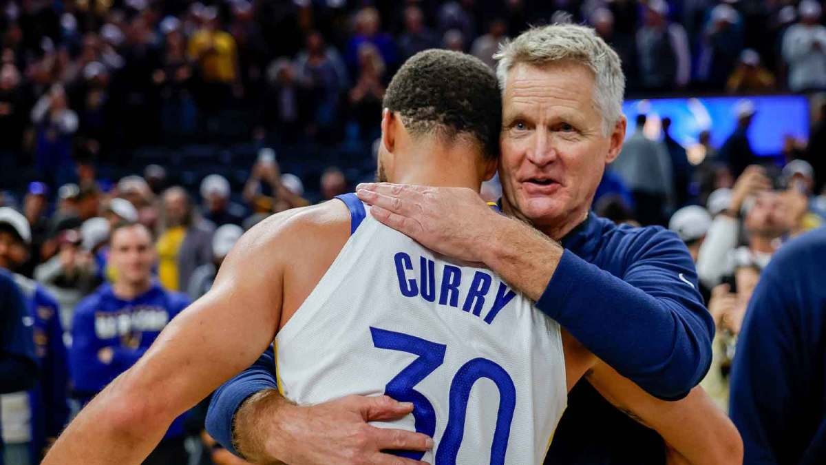 Golden State Warriors guard Stephen Curry (30) embraces head coach Steve Kerr after their overtime win against the Denver Nuggets at Chase Center.