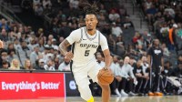 San Antonio Spurs guard Stephon Castle (5) dribbles in the first half against the Sacramento Kings at Frost Bank Center.