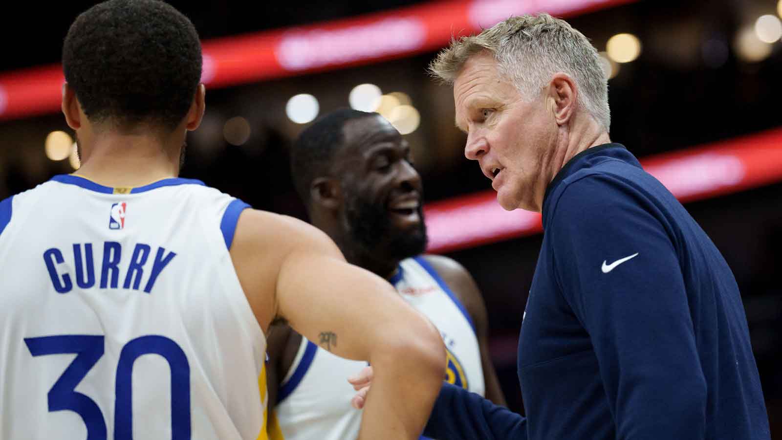 Golden State Warriors head coach Steve Kerr talks to guard Stephen Curry (30) and forward Draymond Green (23) during the first half against the New Orleans Pelicans at Smoothie King Center.