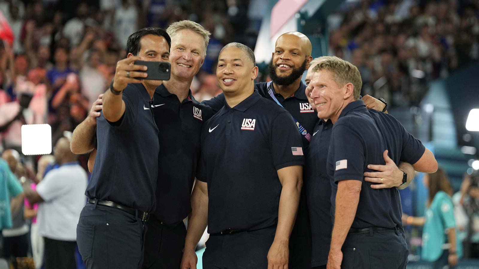 United States assistant coach Erik Spoelstra takes a selfie with head coach Steve Kerr and assistant coach Tyronn Lue and assistant coach Mark Few in the men's basketball gold medal game during the Paris 2024 Olympic Summer Games at Accor Arena. 