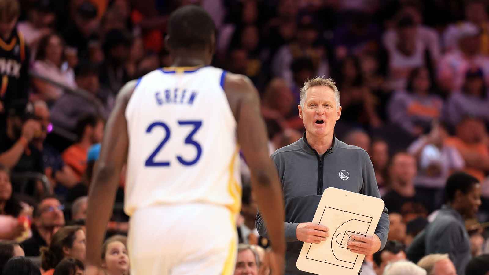 Golden State Warriors head coach Steve Kerr talks to forward Draymond Green (23) during the first half against the Phoenix Suns at Footprint Center.