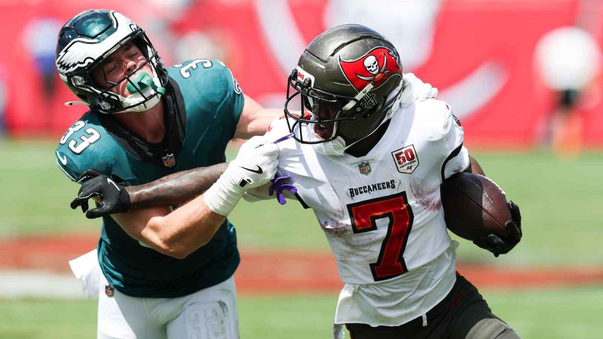 Tampa Bay Buccaneers running back Bucky Irving (7) attempts to stiff arm Philadelphia Eagles cornerback Cooper Dejean (33) during the first quarter at Raymond James Stadium.