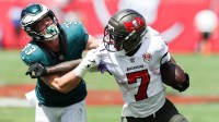 Tampa Bay Buccaneers running back Bucky Irving (7) attempts to stiff arm Philadelphia Eagles cornerback Cooper Dejean (33) during the first quarter at Raymond James Stadium.