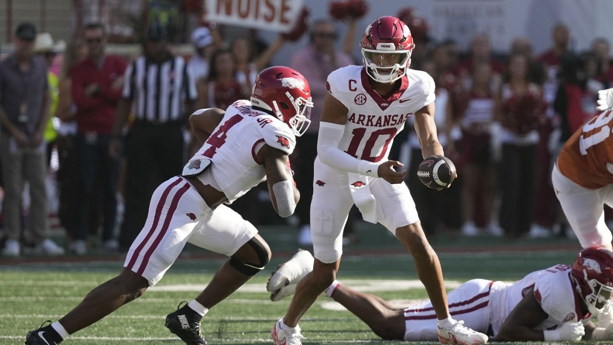 Arkansas Razorbacks quarterback Taylen Green (10) hands the ball off to running back Mike Washington Jr. (4) during the first half against the Texas Longhorns at Darrell K Royal-Texas Memorial Stadium.