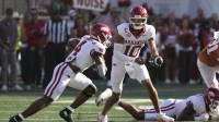 Arkansas Razorbacks quarterback Taylen Green (10) hands the ball off to running back Mike Washington Jr. (4) during the first half against the Texas Longhorns at Darrell K Royal-Texas Memorial Stadium.