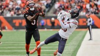 Cincinnati Bengals wide receiver Tee Higgins (5) catches a 44-yard touchdown pass thrown by quarterback Joe Flacco (not pictured) against Chicago Bears cornerback Nahshon Wright (26) during the second quarter at Paycor Stadium.