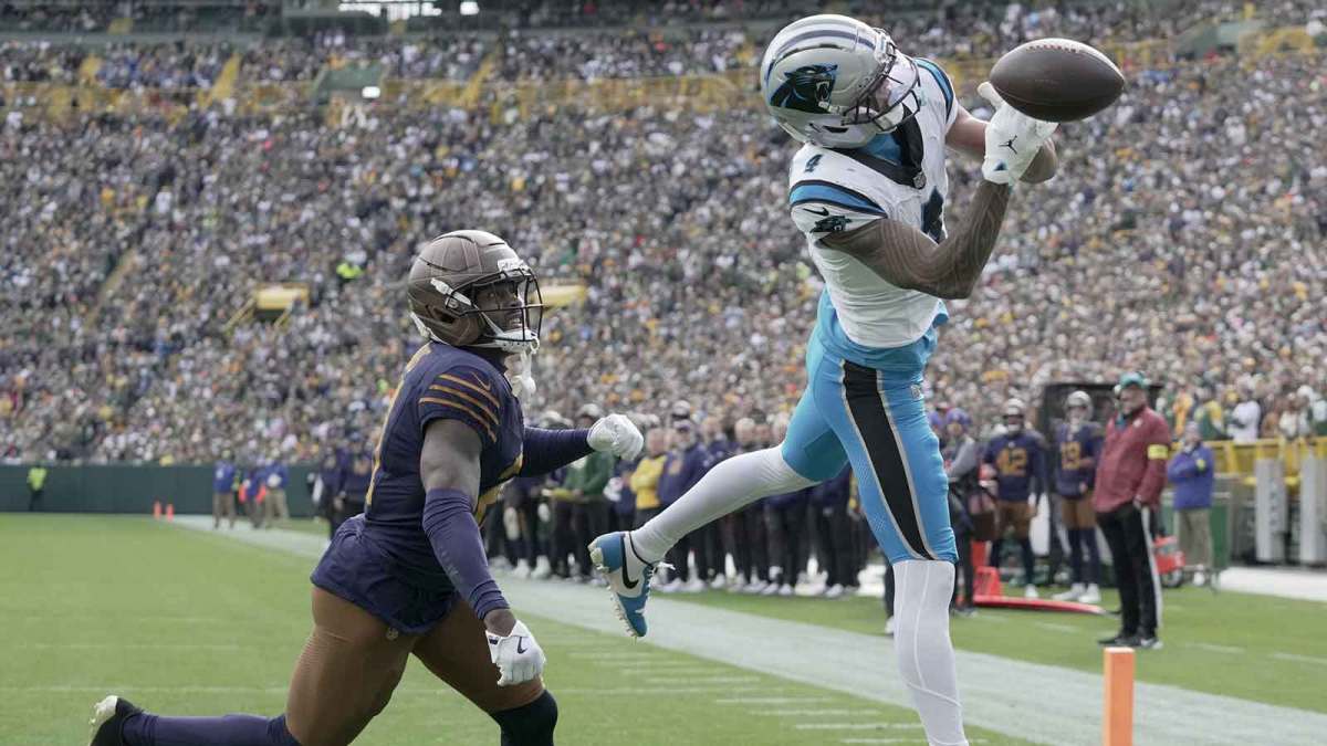 Carolina Panthers wide receiver Tetairoa McMillan is able to catch a would-be touchdown while being covered by Green Bay Packers cornerback Nate Hobbs (21) during the second quarter of their game at Lambeau Field.