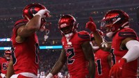 Houston Texans wide receiver Christian Kirk (13) celebrates with wide receiver Xavier Hutchinson (19) after scoring a touchdown against the Buffalo Bills in the second quarter at NRG Stadium.