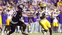 Louisiana State Tigers running back Harlem Berry (22) runs against Texas A&M Aggies linebacker Taurean York (21) during the first half at Tiger Stadium.