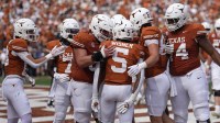Texas Longhorns celebrate after running back Quintrevion Wisner (5) runs for a touchdown in the first half against the Vanderbilt Commodores at Darrell K Royal-Texas Memorial Stadium.