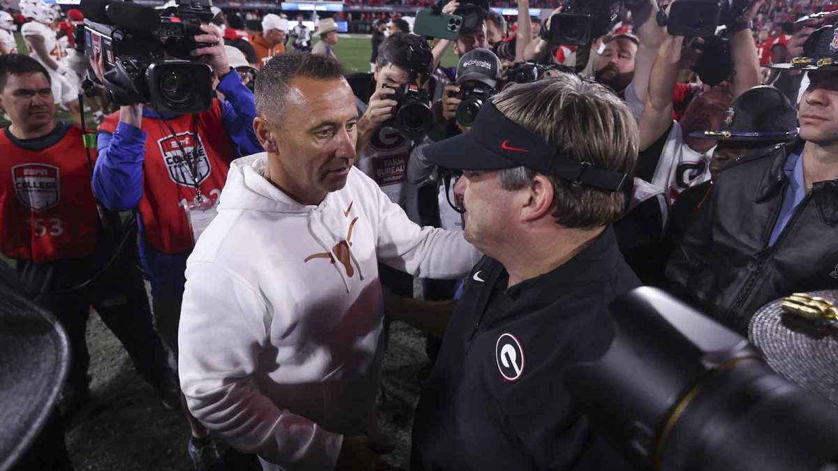Texas Longhorns head coach Steve Sarkisian and Georgia Bulldogs head coach Kirby Smart interact after a game at Sanford Stadium.