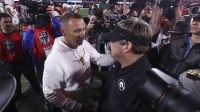 Texas Longhorns head coach Steve Sarkisian and Georgia Bulldogs head coach Kirby Smart interact after a game at Sanford Stadium.