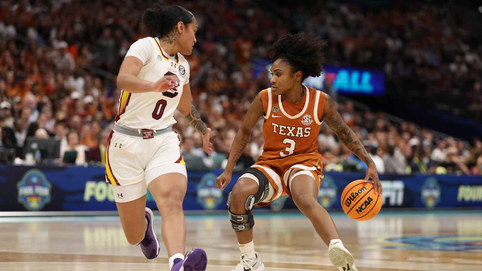 Texas Longhorns guard Rori Harmon (3) dribbles against South Carolina Gamecocks guard Te-Hina Paopao (0) during the first half in a semifinal of the women's 2025 NCAA tournament at Amalie Arena.