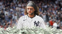 Bo Bichette photoshopped in Yankees jersey with cash all around the graphic.