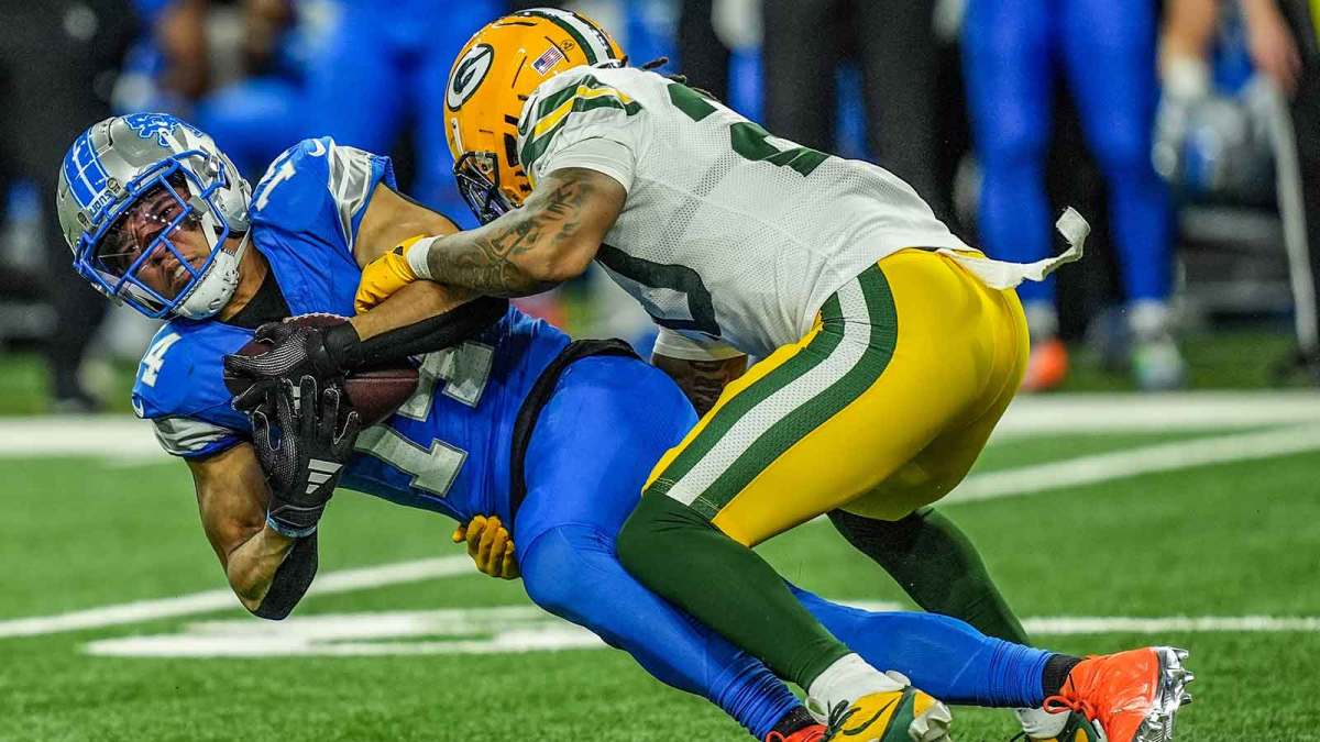 Detroit Lions wide receiver Amon-Ra St. Brown makes a catch while hit by Green Bay Packers safety Javon Bullard during the Thursday Night Football game at Ford Field in Detroit on Thursday, Dec. 5, 2024.
