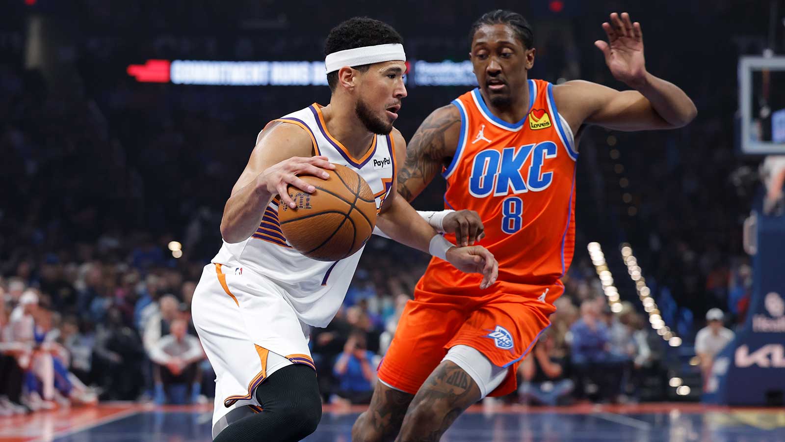 Suns guard Devin Booker (1) drives to the basket past Oklahoma City Thunder guard Jalen Williams (8) during the first quarter at Paycom Center