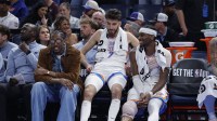 Thunder guard Jalen Williams (8), center Chet Holmgren (7), and guard Shai Gilgeous-Alexander (2) talk while sitting on the bench during the fourth quarter against the Los Angeles Lakers at Paycom Center with Chris Mannix in the background