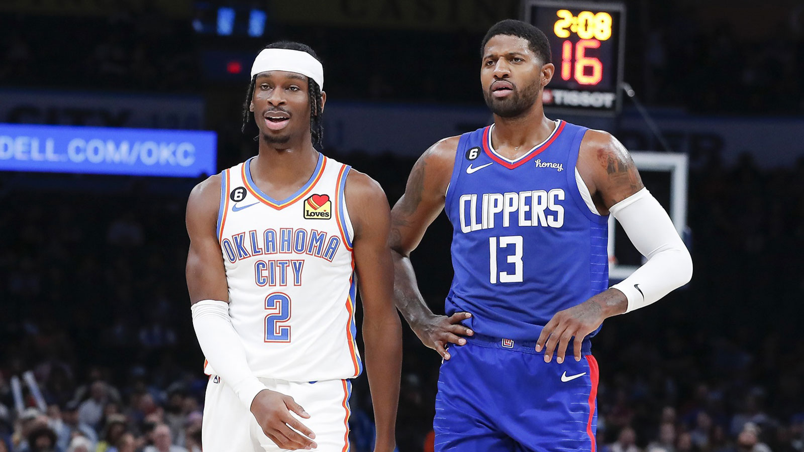 Thunder guard Shai Gilgeous-Alexander (2) and LA Clippers guard Paul George (13) walks down the court during a time out during the first half at Paycom Center
