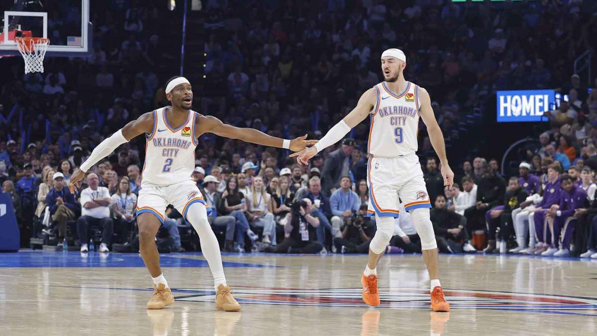 Thunder guard Shai Gilgeous-Alexander (2) and Oklahoma City Thunder guard Alex Caruso (9) celebrate after a basket against the Los Angeles Lakers during the second quarter at Paycom Center