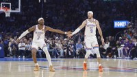 Thunder guard Shai Gilgeous-Alexander (2) and Oklahoma City Thunder guard Alex Caruso (9) celebrate after a basket against the Los Angeles Lakers during the second quarter at Paycom Center