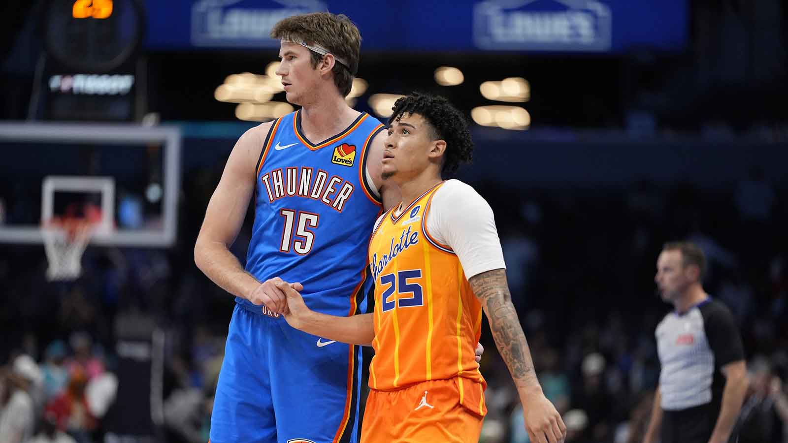 Thunder center Branden Carlson (15) and Charlotte Hornets guard KJ Simpson (25) shake hands after the game at Spectrum Center