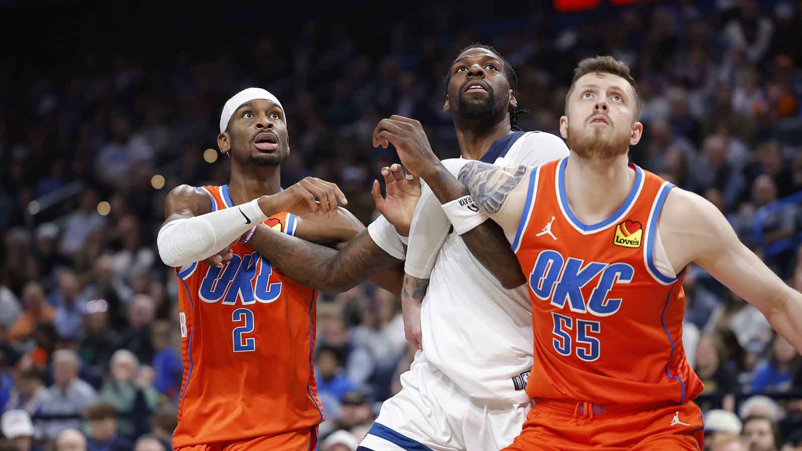 Thunder guard Shai Gilgeous-Alexander (2), center Isaiah Hartenstein (55) and Minnesota Timberwolves center Naz Reid (11) react as a rebound comes down during the second half at Paycom Center