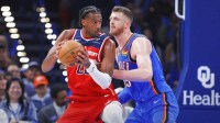 Wizards center Alex Sarr (20) moves the ball as Oklahoma City Thunder center Isaiah Hartenstein (55) defends during the second half at Paycom Center with Thunder head coach Mark Daigneault in the background
