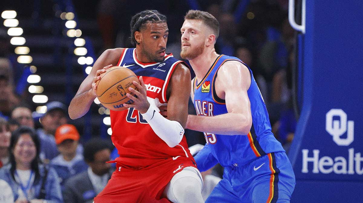 Wizards center Alex Sarr (20) moves the ball as Oklahoma City Thunder center Isaiah Hartenstein (55) defends during the second half at Paycom Center with Thunder head coach Mark Daigneault in the background