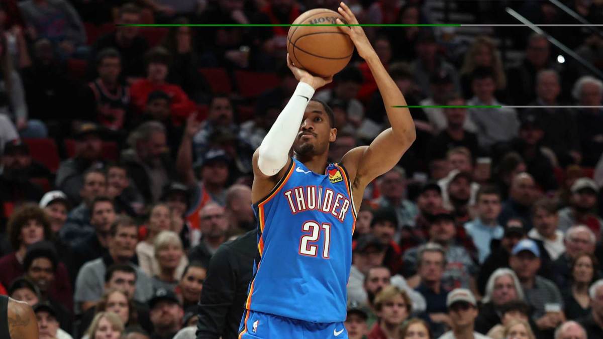 Thunder guard Aaron Wiggins (21) shoots the ball over Portland Trail Blazers center Duop Reath (26) during the first half at Moda Center with the Kings logo in the background