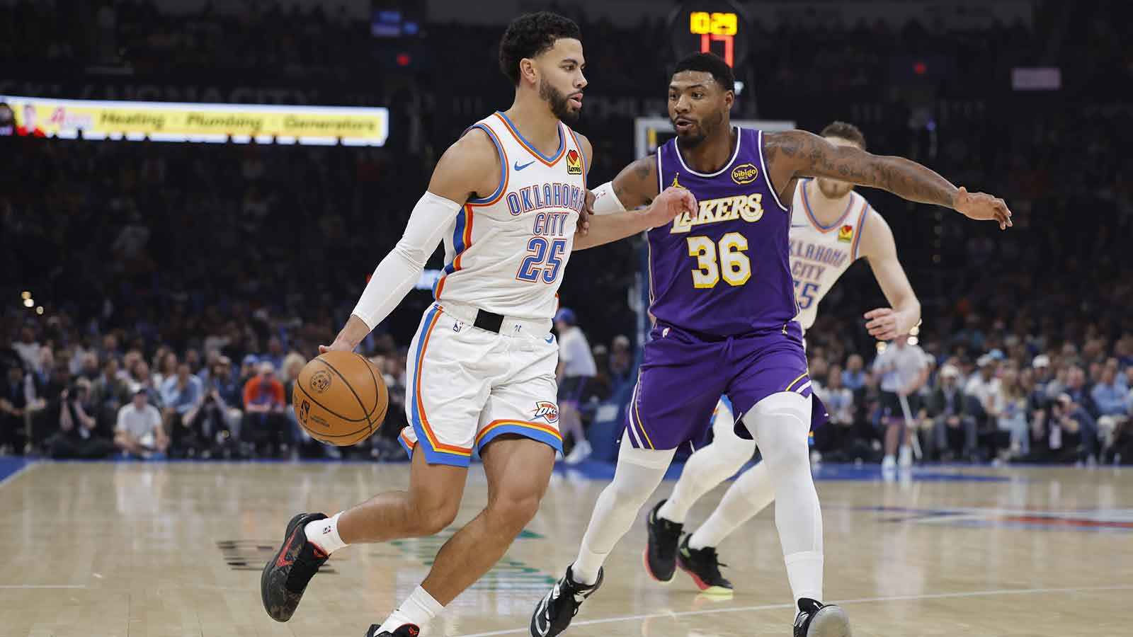 Thunder guard Ajay Mitchell (25) moves the ball around Los Angeles Lakers guard Marcus Smart (36) during the second quarter at Paycom Center