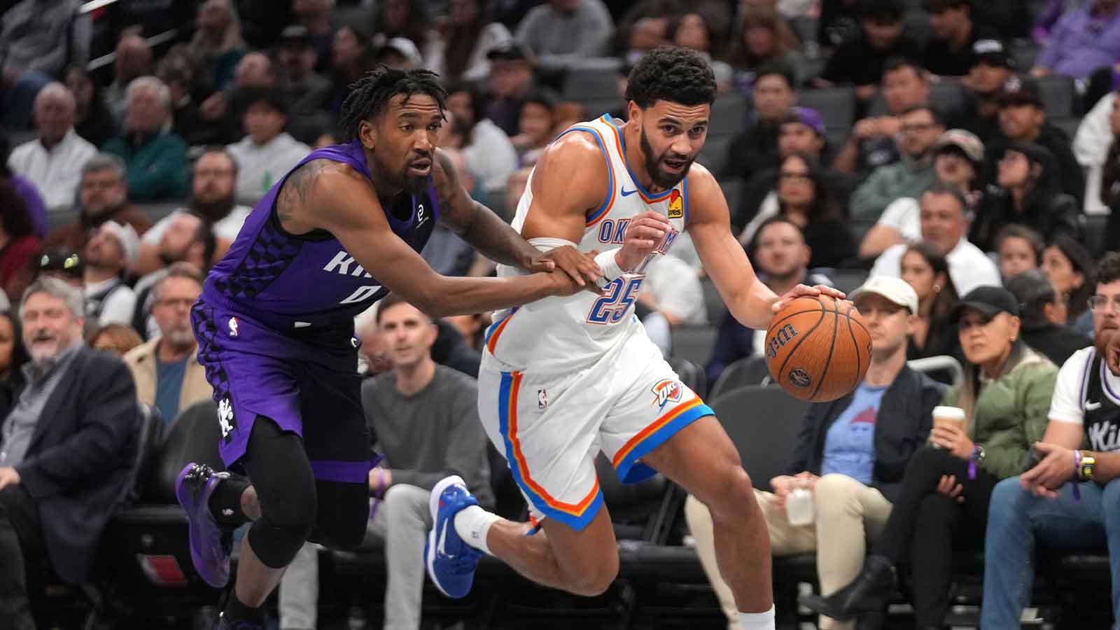 Thunder guard Ajay Mitchell (25) dribbles past Sacramento Kings guard Malik Monk (0) in the third quarter at the Golden 1 Center