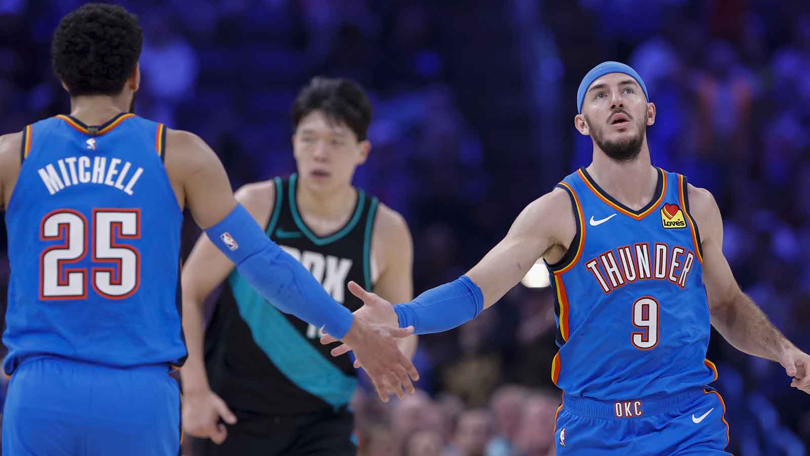 Thunder guard Alex Caruso (9) and guard Ajay Mitchell (25) celebrate after a play against the Portland Trail Blazers during the second quarter at Paycom Center