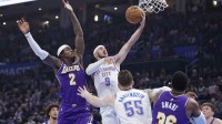 Thunder guard Alex Caruso (9) goes up for a basket beside Los Angeles Lakers forward Jarred Vanderbilt (2) during the second quarter at Paycom Center