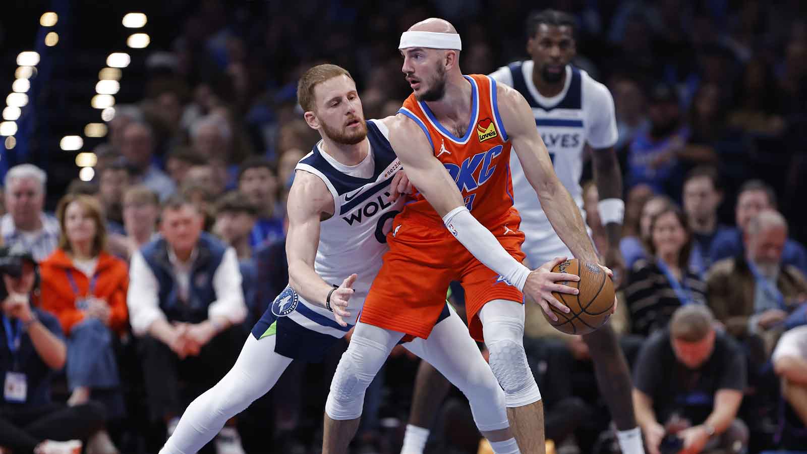 Timberwolves guard Donte DiVincenzo (0) defends Oklahoma City Thunder guard Alex Caruso (9) during the second half at Paycom Center