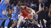 Thunder guard Cason Wallace (22) steals the ball away from New Orleans Pelicans guard Jeremiah Fears (0) during the second quarter at Paycom Center with Thunder's Alex Caruso and Lu Dort in the background
