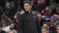 Thunder head coach Mark Daigneault reacts on the bench against the Atlanta Hawks during the first half at State Farm Arena with the Trail Blazers logo and Thunder guard Ajay Mitchell in the background