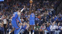 Thunder guard Cason Wallace (22) shoots a three point basket against the New Orleans Pelicans during the first quarter at Paycom Center with FanDuel's Chandler Parsons in the background