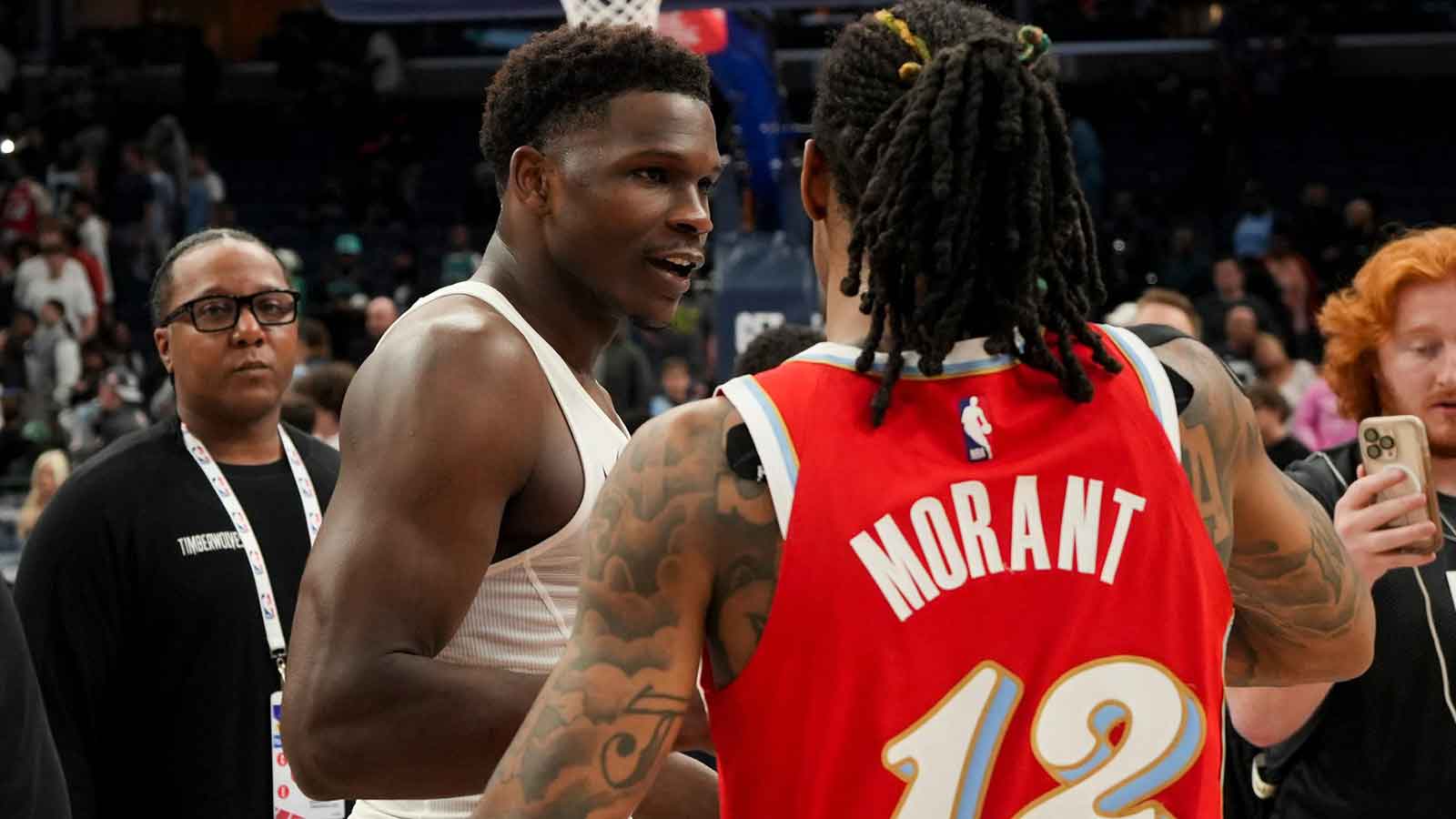 Timberwolves' Anthony Edwards (5) and Grizzlies' Ja Morant (12) hug after the Timberwolves defeated the Grizzlies 141-125 at FedExForum in Memphis, Tenn., on Thursday, April 10, 2025